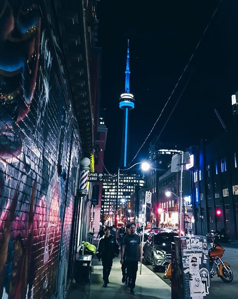 The CN Tower in Toronto, Ontario illuminated blue and white for dystonia.