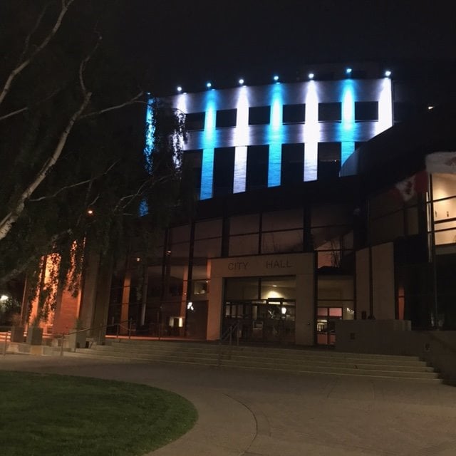 City Hall in Lethbridge illuminated blue and white for dystonia.